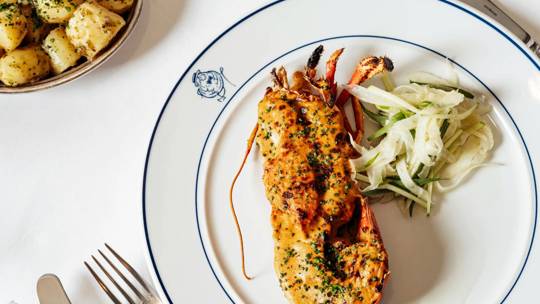 Lobster Thermidor beautifully plated at Bentley's, a renowned seafood restaurant in Mayfair, London.